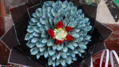 A bouquet made out of blue coloured Kenyan shilling banknotes.
